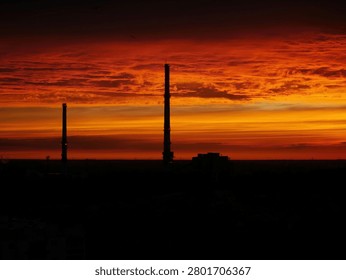 A fiery sunset over clouds and chimneys