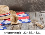 Fiestas Patrias Chile September 18th, Independence Day. Huaso hat, straw hat and creole emboque, on wooden table with flag, copy space. Chilenidad