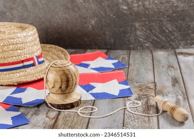 Fiestas Patrias Chile September 18th, Independence Day. Huaso hat, straw hat and creole emboque, on wooden table with flag, copy space. Chilenidad
