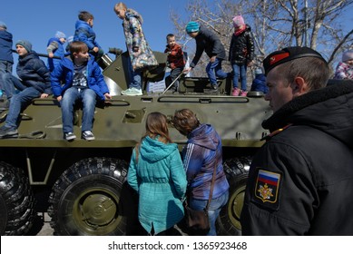 Sevastopol.Crimea/Russia-3.18.2019.Сelebration Of Fifth Anniversary Of Russian Crimea Annexation Military Army Parade Rally Of Putin Followers Navy Marine Soldier And Kids Playing On Armored Car APC