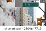 Fifth avenue, 5 ave road sign, Manhattan midtown architecture, New York City 5th av street corner. Traffic crossroad signage, USA. American flag, United States. Steam vapor stack, hot vapour smoke.