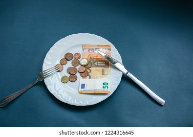 Fifty Euros Lying On The Plate With Fork And Knife. No Money Photo. Poor People Idea. Cents Coins. Small Salary And Pension Not Enough For Food. Social Problems.