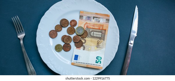 Fifty Euros Lying On The Plate With Fork And Knife. No Money Photo. Poor People Idea. Cents Coins. Small Salary And Pension Not Enough For Food. Social Problems.