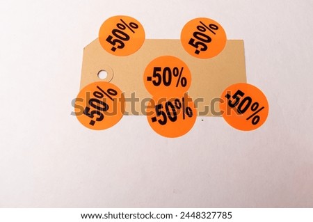 fifty percent off, six stickers stuck on a brown price tag