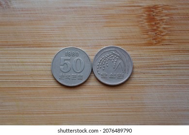 Fifty South Korean Won Coin On Wooden Background, Obeverse Rice Ear And Value , Reverse Central Numeral, Date 1980 Year, 50 Wons Korea Collectible Coin, Collectors, Numismatic, Metal Money