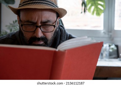 Fifty Year Old Spanish Man With Hat With A Book