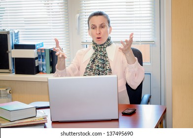 A Fifty Years Old Woman Working In Office With A Laptop Computer Is Very Angry With The Modern Technology