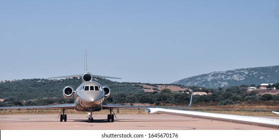 Figari, Corsica - July 2013: Amazing Shot Of A Beautiful Private Business Jet Dassault Falcon 7X On The Tarmac Of Figari Airport. Super Rich Lifestyle During Summertime.