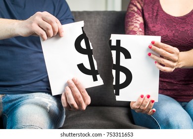 Fight About Money Or Financial Argument Concept. Man And Woman Holding Ripped Paper With Dollar Sign.