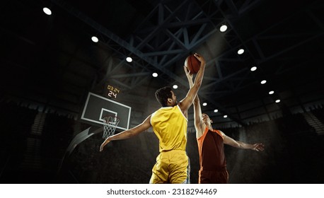 Fight for ball. Young basketball players in action with basketball ball at 3d model sports arena. Concept of competition, rivals, games, plays, sport and ad. Athletes wearing team colors sportswear - Powered by Shutterstock