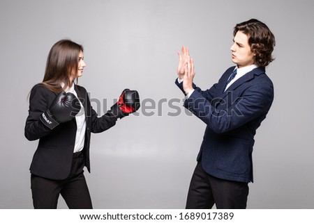 The fight between the two investors. Business couple fight. Woman in box gloves fight with man.