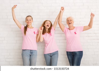 Fight Breast Cancer. Three Excited Women Of Diverse Age Wearing Pink Ribbon T-Shirts Holding Hands Against White Brick Wall - Shutterstock ID 1513150724