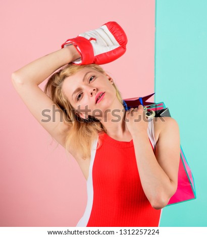 Fight for discount. Woman in boxing glove carry shopping bags. She won discount in battle. Get ready for shopping. Tired lady boxer shopping sale season. How win at betting. Buy on auction. Beat bet.