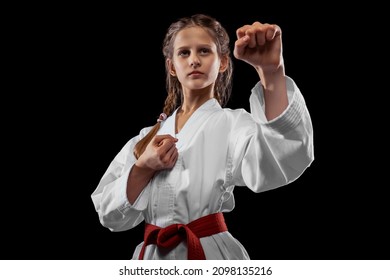 Fight. One Young Girl, Teen, Taekwondo Athlete Posing Isolated Over Dark Background. Concept Of Sport, Education, Skills, Workout, Healthy Lifestyle And Ad. Power And Energy.