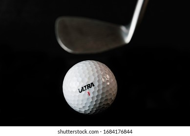 The Fight with virus. Allegory. Golf ball and golf club on black background. ( ULTRA word is not a brand, it is kind (type) of balls.)