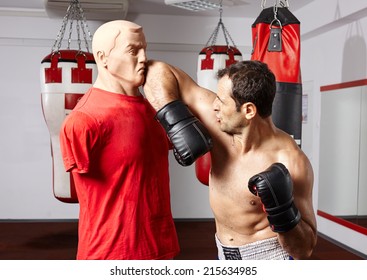 Fighter Exercising Muay Thai Style Elbow Technique On A Mannequin