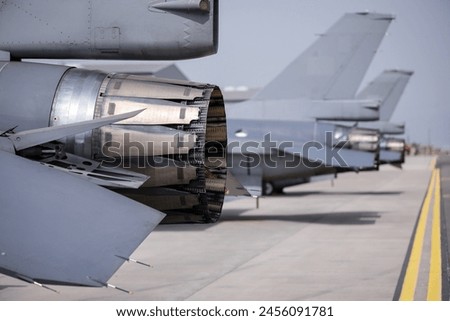 Fighter jet exhaust nozzle detail on a lot of fighter airplanes in parking position. 