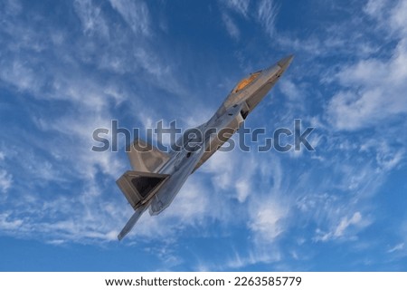 Fighter Jet in Flight. Armed interceptor F-22 raptor flying fast on a combat mission. 