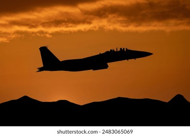 Fighter jet at sunset flying above mountains. Fighter pilot on a combat mission  in modern military aeroplane.  - Powered by Shutterstock