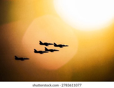 Fighter jets flying in precise formation across a vibrant sunset sky
