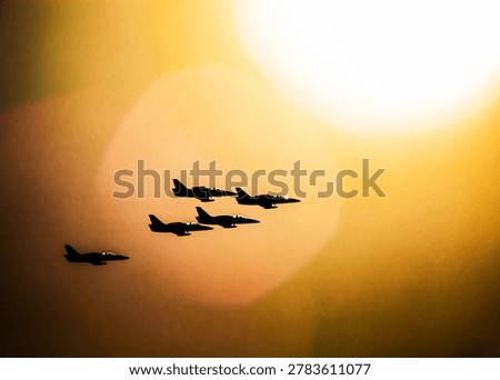 Fighter jets flying in precise formation across a vibrant sunset sky