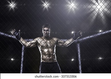 Fighter In Mma Cage Arena Front View