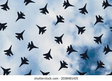 Fighter pattern on the background of the cloudy sky. Military aircraft.