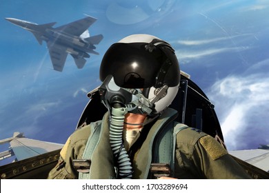 Fighter pilots cockpit view under cloudy blue sky