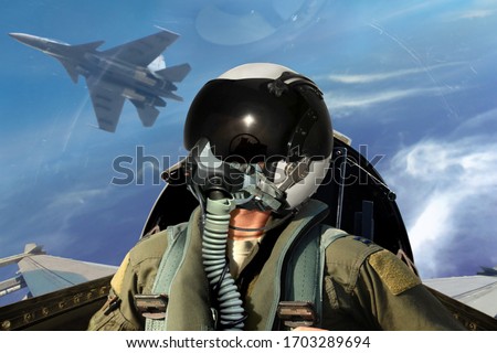 Fighter pilots cockpit view under cloudy blue sky