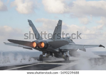 Fighter takes off from an aircraft carrier.