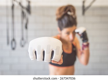 Fighter Woman Fist Close Up. Straight Focus On The Glove With The Rest Of The Image On Blur. Concept About Sport And People