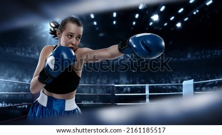 Fighting. Collage with young female professional boxer in boxing gloves punching in flashlights over dark drawn boxing ring background. Sport, competition, power, action concept. Poster