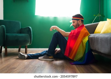 Fighting For Equality. Sad Gay Man Wrapped A Rainbow Flag And Ready To Defend The LGBTQ Community