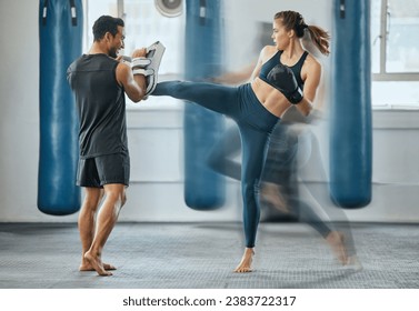 Fighting female training with coach, learning kickboxing exercise at gym and doing cardio fitness workout for wellness with trainer at health club. Woman and man staying, active, healthy and sporty - Powered by Shutterstock