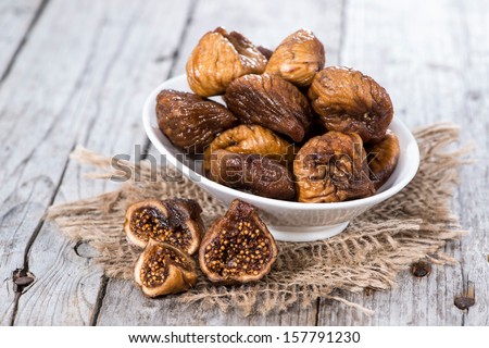 Figs (dried) on a wooden background