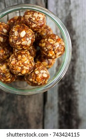 Figs energy balls with nuts in glass jar on wooden background