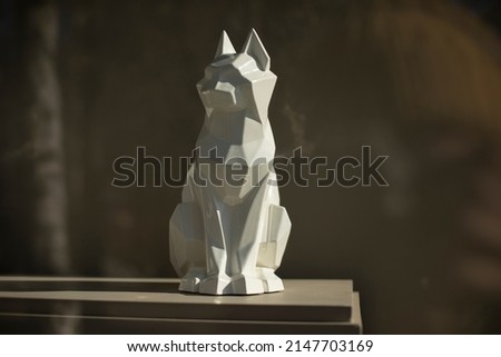 Figure of cat. Sculpture made of white plastic. Interior details. Item for decoration.
