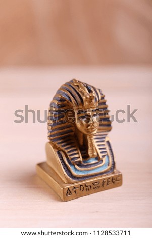 A figure of a golden sphinx