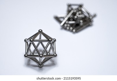 A figure from a magnetic constructor on a white isolate. Round magnetic balls. A toy for children made of metal.