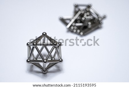 A figure from a magnetic constructor on a white isolate. Round magnetic balls. A toy for children made of metal.