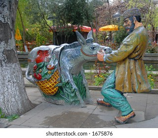 Figure Of A Man Pulling A Stubborn Donkey