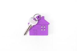 Figure Of A Mini House Of Purple Color With Keys On An Isolated White Background.