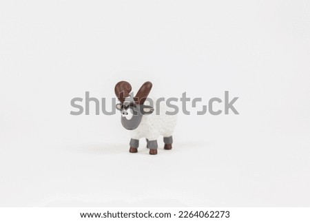 a figure of a ram children's toy on a white background