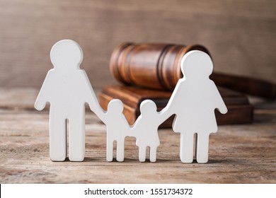 Figure In Shape Of People And Gavel On Wooden Table. Family Law Concept