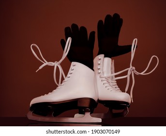 Figure Skates Close Up. Sport Equipment .Black Winter Gloves.