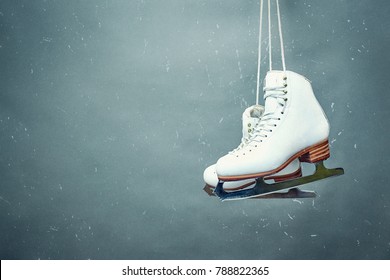 Figure skates are suspended against the background