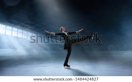 Figure skating couple in professional ice arena.