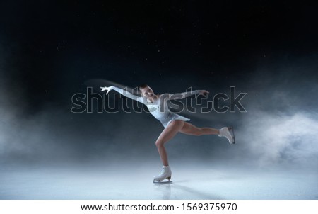 Figure skating girl skating on ice.