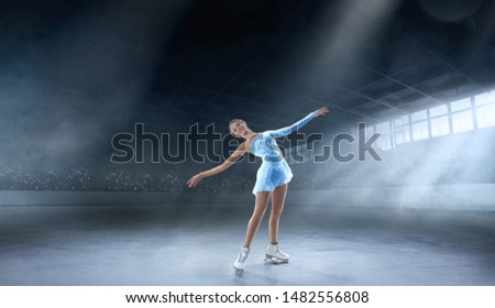 Figure skating girl in professional ice arena.