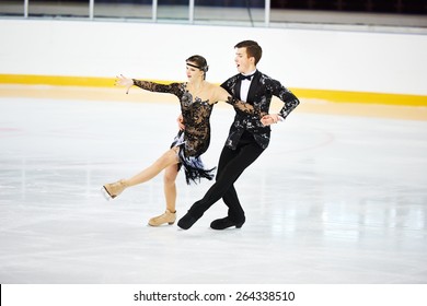 figure skating of young skaters pair at sports arena - Shutterstock ID 264338510